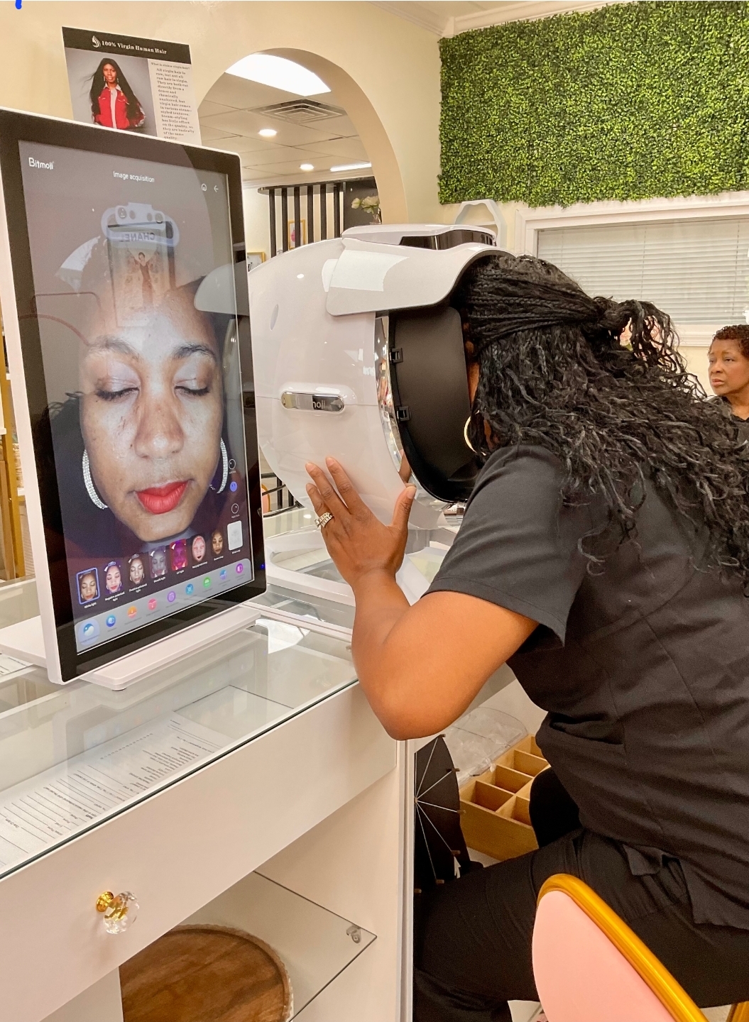 Skin Analysis — Client using Bitmoli skin analysis machine with face scan on screen