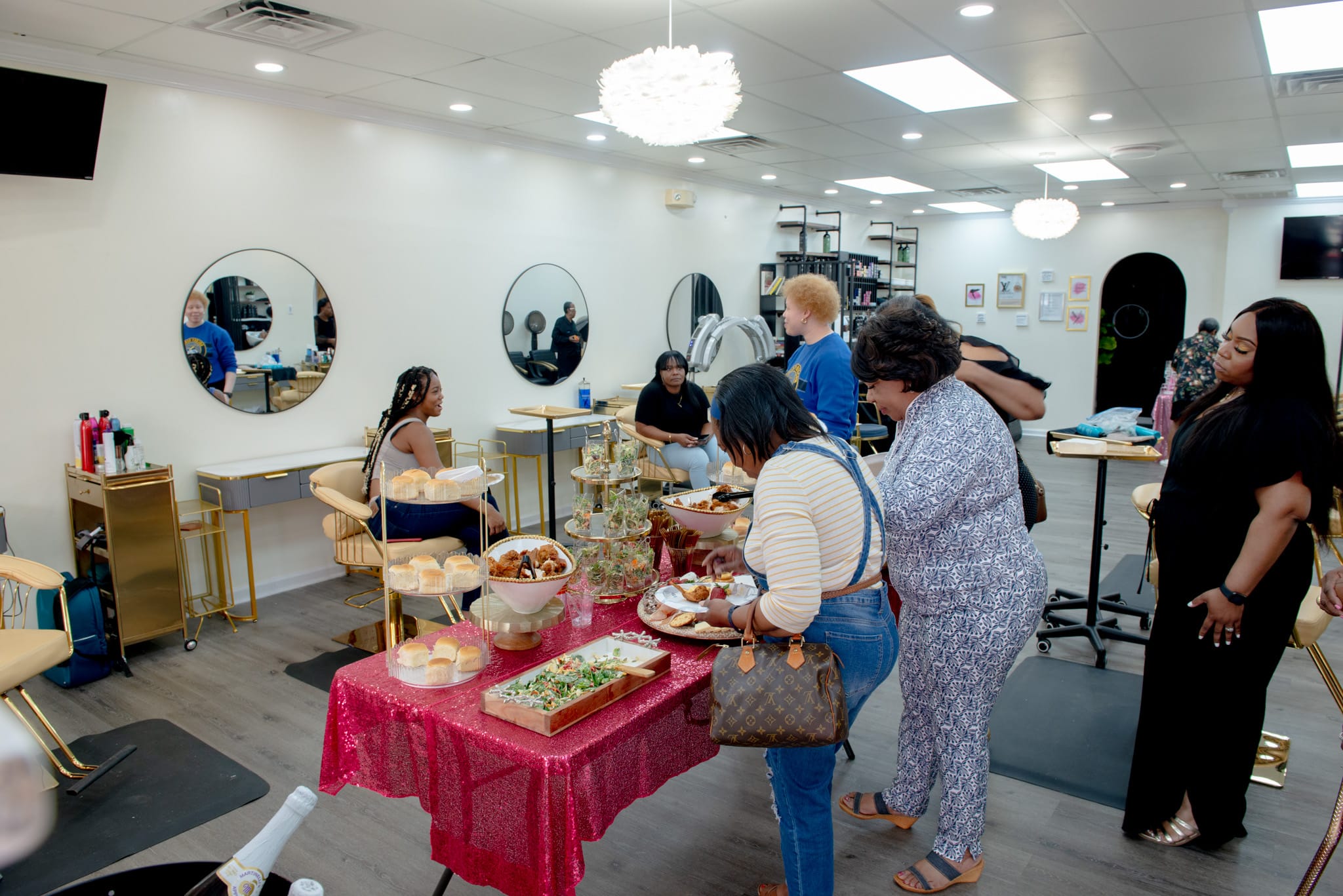 Spa party guests enjoying food table at Sinkor Beauty Salon Delaware — salon buyout party experience