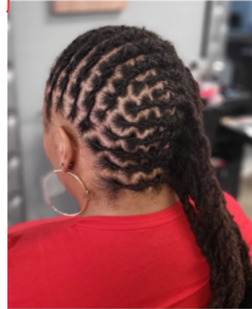 Barrel roll locs woman in red top — creative loc styling Sinkor Beauty Salon Delaware